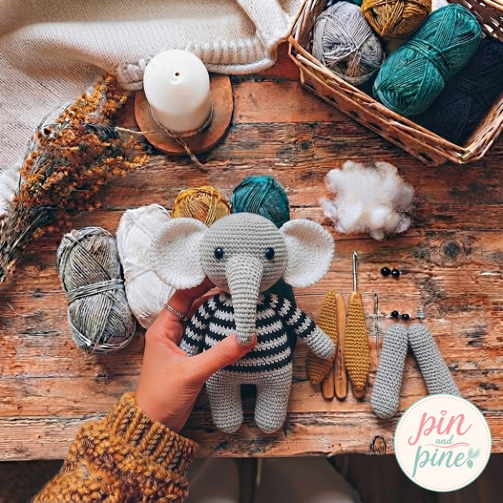 Striped black and white body of the crochet elephant amigurumi stuffed and joined to the finished head