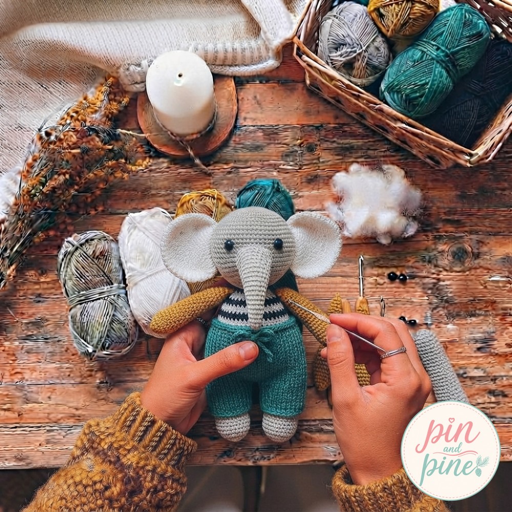 Mustard yellow arms and legs being sewn onto the striped crochet elephant amigurumi body