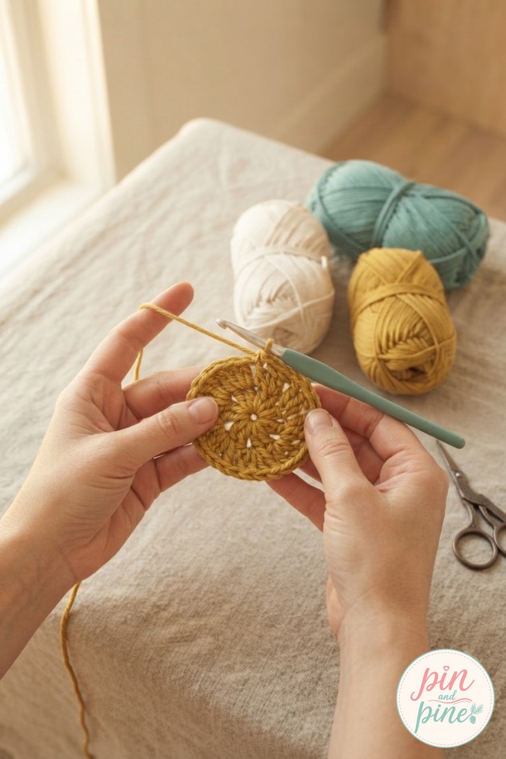 Hands forming a mustard magic ring, the first center round of the crochet flower blanket pattern daisy motif